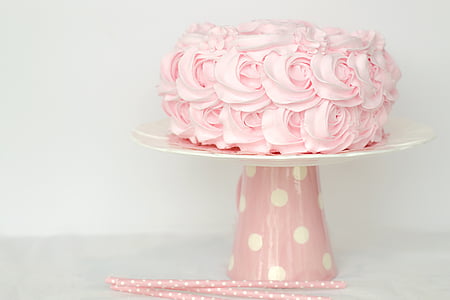 pink icing coated cake on white and pink cake stand thumbnail
