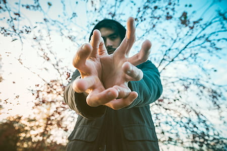 close up photo of man standing on forest thumbnail