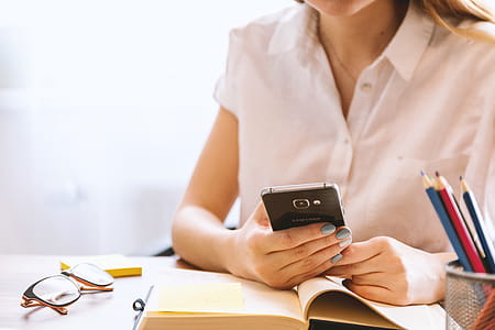 Young woman uses smartphone at the office thumbnail
