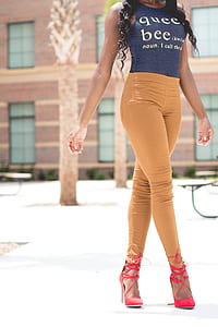person in blue shirt and brown jeans walking thumbnail