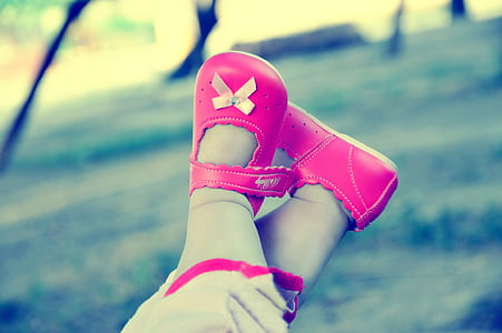 toddler wearing pair of pink leather shoes thumbnail