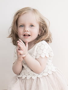 smiling girl wearing dress near wall thumbnail
