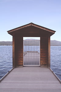 brown wooden dock surrounded by water thumbnail