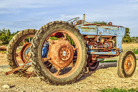 blue and red farm tractor on grass field thumbnail