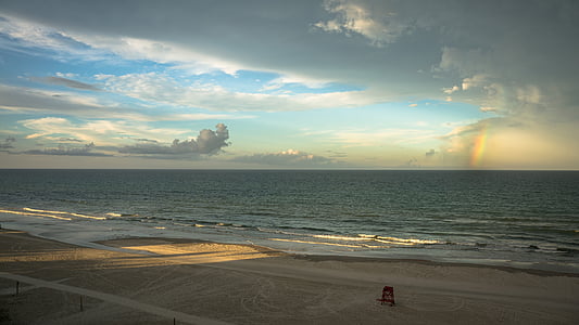 silhouette of person near seashore with white and blue sky at day time thumbnail