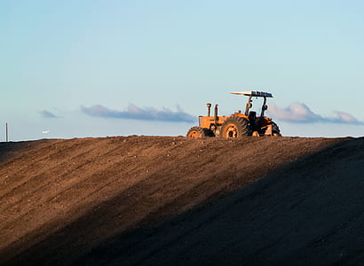 orange tractor on the field thumbnail