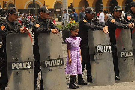 girl standing in the middle of policemen thumbnail