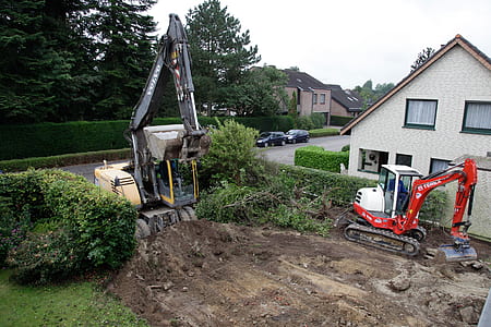 heavy equipment3 beside house thumbnail