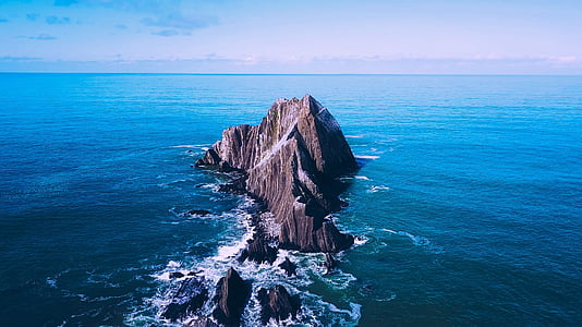 rock formation surrounded with body of water thumbnail
