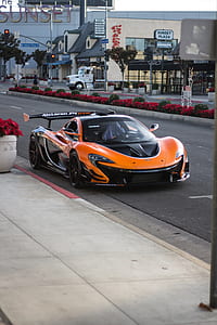 orange and black supercar on road thumbnail