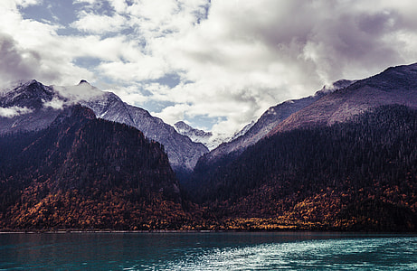 landscape photo of mountains and body of water thumbnail
