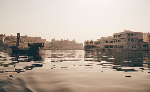 white building near body of water thumbnail