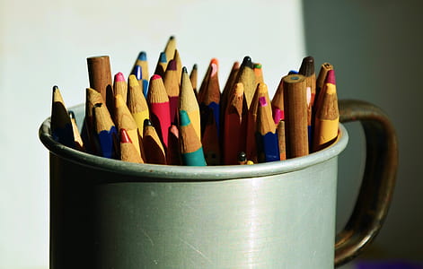 assorted color pencil on grey mug thumbnail