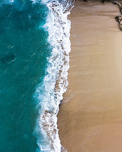 aerial view photography of body of water and sand thumbnail