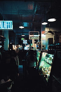 person standing beside glass show case thumbnail