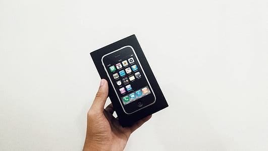 person holding black iPhone box thumbnail