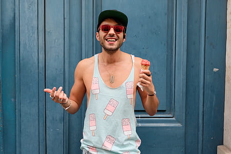 Person in Teal Ice Cream Print Tank Top Holds Ice Cream thumbnail
