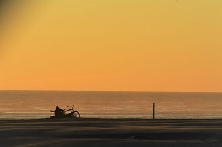 man sitting near shore thumbnail
