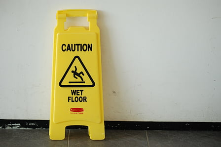 wet floor signage leaning on wall thumbnail