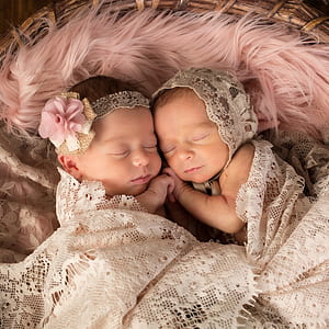 close up photography of two sleeping baby on bed thumbnail