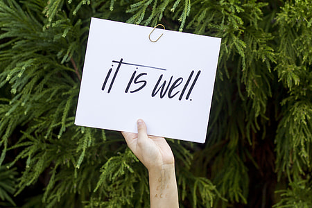person holding paper with It Is Well text thumbnail
