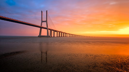 wide angle photo of suspension bridge during sunset thumbnail