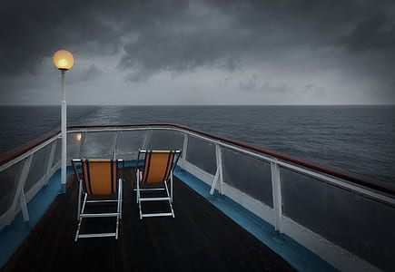 two orange folding chairs inside yacht thumbnail