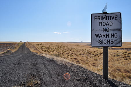 empty road beside primitive road no warning signs signage thumbnail