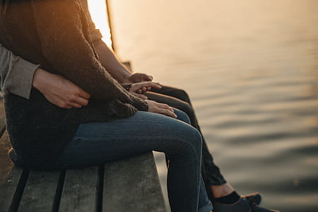 couple sitting on wooden dock thumbnail