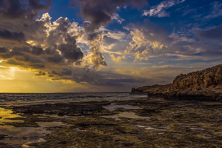 rock formation near sea at daytime thumbnail