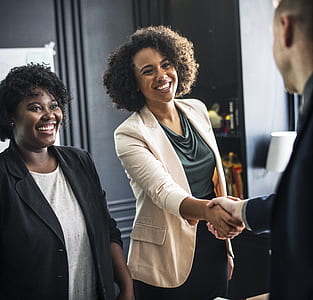 man and woman shaking hands while smiling thumbnail