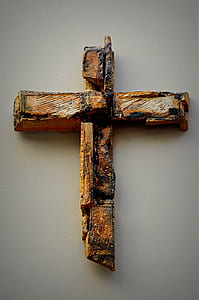 brown wooden cross on wall thumbnail
