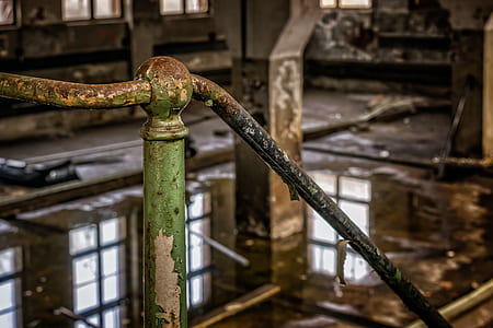 selective focus photography of rusted green metal stair rail bar thumbnail