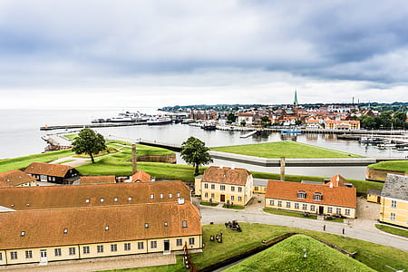 high-angle photo of concrete houses near body of water thumbnail