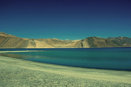 body of water and mountains thumbnail