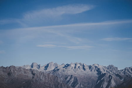 rocky mountain under blue cloudy skies thumbnail