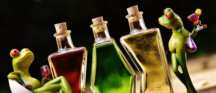 three glass bottles beside frog figurine thumbnail