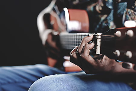person holding acoustic guitar thumbnail