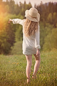 woman walking grass pointing a direction thumbnail