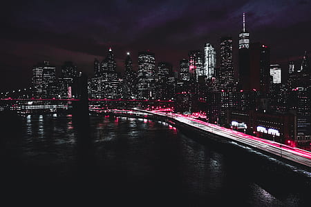 concrete bridge beside high-rise building during nighttime thumbnail