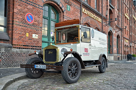 classic white vehicle near brown concrete building thumbnail