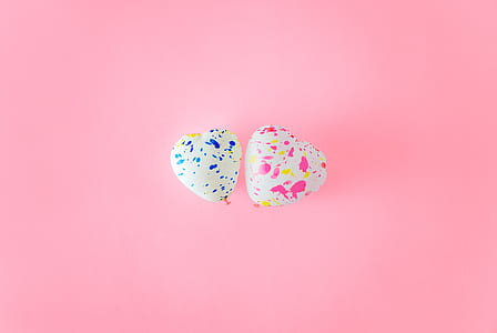 two heart-shaped white-and-blue and white-and-pink balloons beside each other thumbnail