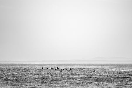 grayscale photo of people on beach thumbnail