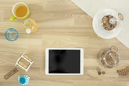 white iPad near mug, bottle, pitcher flat lay photography thumbnail