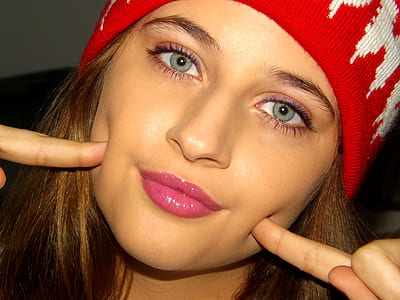 close shot of woman wearing red and white knit cap thumbnail