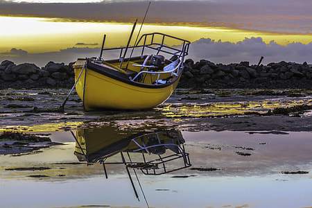 photo of yellow and black outboard motorboat on body of water thumbnail