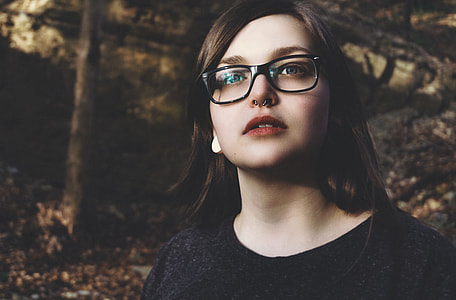 woman wearing black plastic framed eyeglasses and scoop neck shirt thumbnail