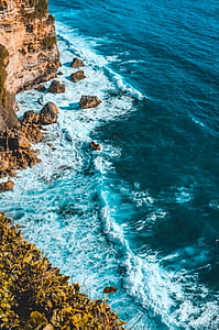 rock mountain near body of water thumbnail