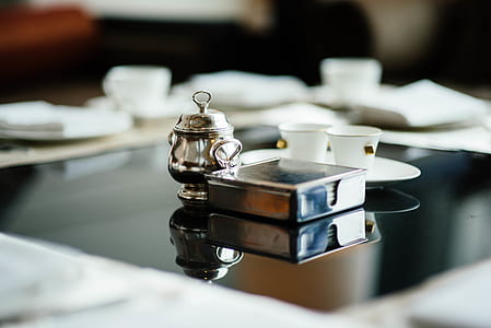 square gray stainless steel holder and gray stainless steel delight pot in selective focus photography thumbnail