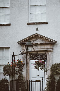 gray concrete house with flowers and gate thumbnail